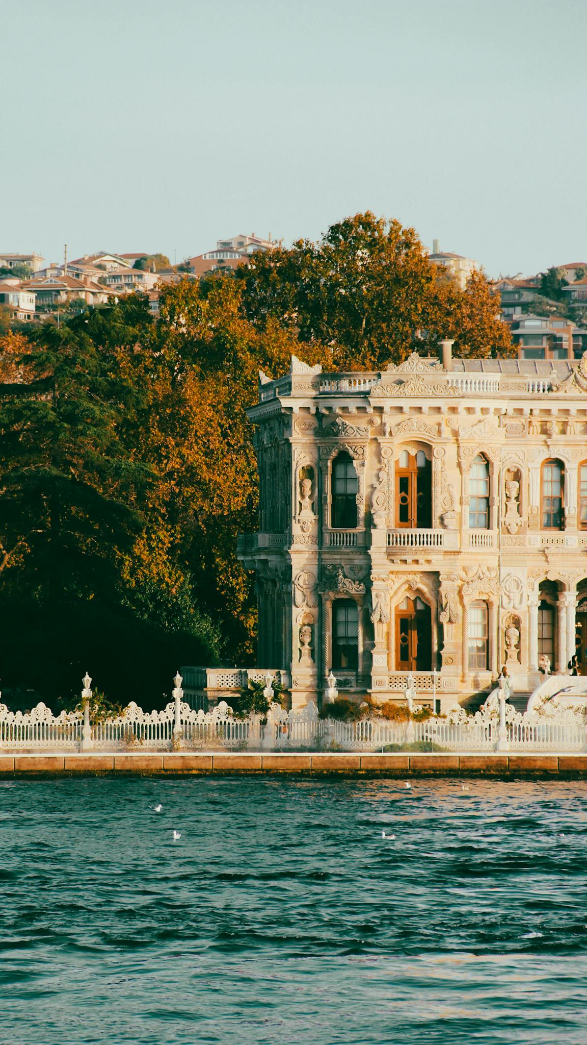 Discover the stunning architecture of Beylerbeyi Palace on the Bosphorus, bathed in autumn light.